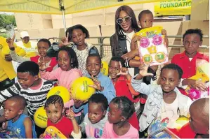  ??  ?? Naomi Campbell with children at the Motsepe Foundation’s Christmas with Our People event at Orlando Stadium.