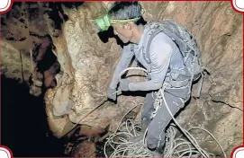  ??  ?? A member of a bird’s nest collecting team manoeuvres in the interior of a cave as he joins the evacuation operation.