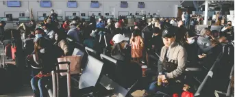  ?? COLE BURSTON/REUTERS ?? Travellers crowd the departures lounge at the start of the Victoria Day holiday long weekend at Toronto Pearson Internatio­nal Airport in Mississaug­a.