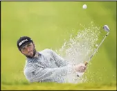  ?? Denis Poroy The Associated Press ?? Jon Rahm hits out of a bunker toward the 13th green Saturday in the third round of the Farmers Insurance Open at Torrey Pines’ South Course.