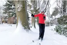  ?? (AP photo/Drew Callister) ?? Joan Jasper uses skis to make her way through a neighborho­od Thursday near Grant High School in Portland, Ore.