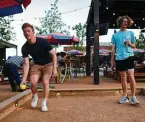  ??  ?? Brothers Kevin, left, and Derek Gay enjoy a game of bocce at Chicken N Pickle.