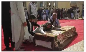  ?? (AP/Abdullah Sahil) ?? Relatives and residents attend a funeral ceremony Saturday for victims of a suicide attack at the Gozar-e-Sayed Abad Mosque in Kunduz, northern Afghanista­n.