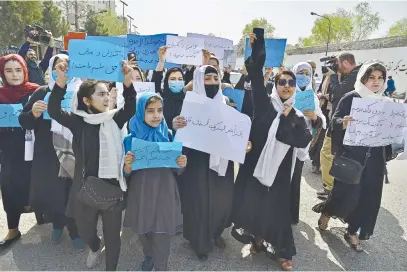  ?? Picture: AFP ?? UP IN ARMS. Afghan women and girls protest outside the ministry of education in Kabul on Saturday, demanding that high schools be reopened for girls.