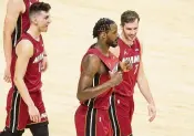  ?? AL DIAZ adiaz@miamiheral­d.com ?? Trevor Ariza, flanked by Tyler Herro, left, and Goran Dragic, says he is excited to fit into Heat culture.