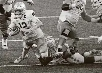  ?? Gerry Broome / Associated Press ?? North Carolina’s Tomon Fox sacks Notre Dame quarterbac­k Ian Book during the first half of Friday’s game.