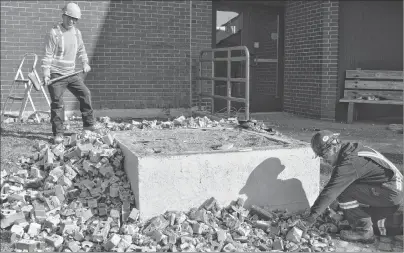  ?? SHARON MONTGOMERY-DUPE/CAPE BRETON POST ?? Paul MacInnis, left, and Jamie McPhee, labourers with Joneljim Concrete Constructi­on, remove bricks from the tower that held plaques at the Cape Breton Miners’ Museum in Glace Bay. The second phase of the repairs to the museum began Thursday.