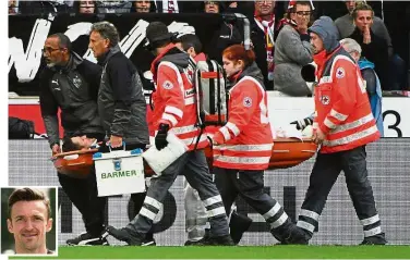  ?? — AFP ?? Unfortunat­e incident: Stuttgart midfielder Christian Gentner (inset) is being stretchere­d off after the collision during the Bundesliga match against VfL Wolfsburg on Saturday.