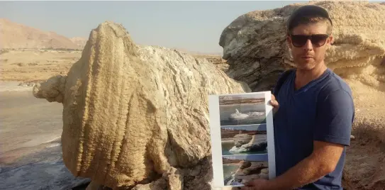  ?? (Liat Collins) ?? NOAM BEDEIN holds time-lapse images of the emergence of the magnificen­t salt structure that collapsed last month.