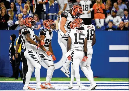  ?? BOBBY ELLIS / GETTY IMAGES ?? Bengals players celebrate after a touchdown against the Colts at Lucas Oil Stadium in Indianapol­is on Sunday. The Bengals won 34-23 after rallying from a 13-point deficit in the final 20 minutes.