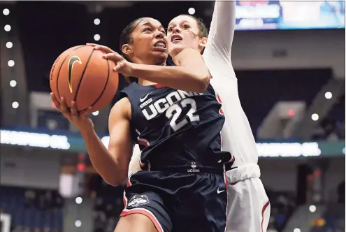  ?? Jessica Hill / Associated Press ?? UConn’s Evina Westbrook goes up to the basket as Arkansas’ Sasha Goforth, right, defends on Sunday.