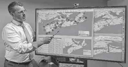  ??  ?? Island Recruiting president Blake Doyle presents labour market data to his team in Charlottet­own using predictive analytics software.