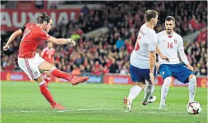  ??  ?? Good start: Gareth Bale shoots Wales ahead in the first half against Serbia in Cardiff last night