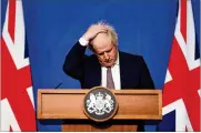  ?? AP ?? Britain’s Prime Minister Boris Johnson gestures as he speaks during a news conference in London on Saturday to announce tightened COVID-19 restrictio­ns.