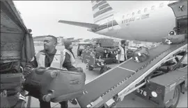  ?? Allen J. Schaben Los Angeles Times ?? OF THE 23 largest U.S. carriers’ earnings, $4.6 billion came from baggage fees. Above, baggage from an American Airlines f light is unloaded at LAX in 2016.