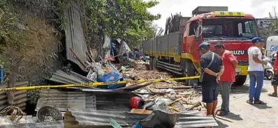  ??  ?? DEADLYHIT A roadside eatery in Taal, Batangas, is reduced into a pile of debris after a truck loaded with sugarcane smashed it on Holy Wednesday. Seven people died in the crash.