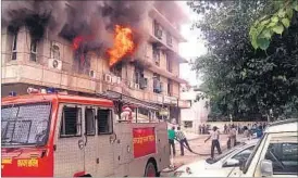  ??  ?? Fire at health directorat­e building in Qaiserbagh on Wednesday. (Below) The charred interiors of the building.