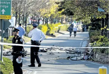  ?? CRAIG RUTTLE/ THE ASSOCIATED PRESS ?? Bicycles and debris lay on a bike path after a motorist drove onto the path near the World Trade Center memorial, striking and killing several people on Tuesday.