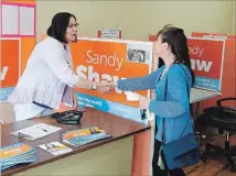  ??  ?? Sandy Shaw, NDP victor in the riding of Hamilton West-Ancaster Dundas, greets a volunteer at her Dundas campaign office on Tuesday.