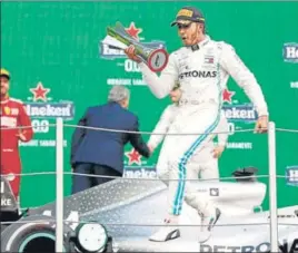 ?? AP ?? Lewis Hamilton celebrates on the podium after winning the Formula One Mexico Grand Prix at the Hermanos Rodriguez racetrack in Mexico City on Saturday.