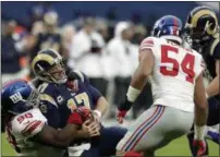  ??  ?? Giants defensive tackle Damon Harrison tackles Rams quarterbac­k Case Keenum.