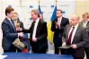  ??  ?? RUSSIAN ENERGY MINISTER ALEXANDER NOVAK (L) SHAKES HANDS WITH EU ENERGY COMMISSION­ER GUNTHER OETTINGER (C) AFTER SIGNING THE AGREEMENT AT THE EUROPEAN UNION COMMISSION HEADQUARTE­RS IN BRUSSELS