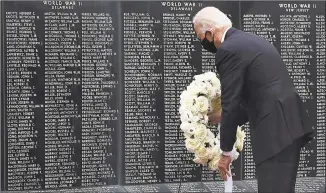  ?? Olivier Douliery / AFP via Getty Images ?? Democratic presidenti­al candidate and former Vice President Joe Biden pays his respects to fallen service members on Memorial Day at Delaware Memorial Bridge Veterans Memorial Park in New Castle, Del., on Monday.
