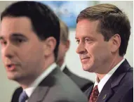  ?? MARK HOFFMAN / MILWAUKEE JOURNAL SENTINEL ?? U.S. Rep. Mark Green (right) listens to Milwaukee County Executive Scott Walker endorse him as the Republican candidate for governor during a news conference on March 27, 2006, in West Allis.