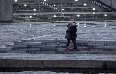  ?? Steve Mellon/Post-Gazette ?? NEW YEAR’S HUG A couple celebrates New Year’s Eve with an embrace at Point State Park.