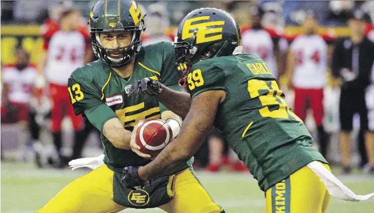  ?? LARRY WONG ?? Edmonton Eskimos quarterbac­k Mike Reilly, left, is the front-runner for the most outstandin­g player award with a CFL-best 5,536 yards passing and 30 touchdowns.