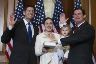  ?? JOSE LUIS MAGANA — THE ASSOCIATED PRESS FILE ?? House Speaker Paul Ryan of Wis. administer­s the House oath of office to Rep. Austin Scott, R-Ga., during a mock swearing in ceremony on Capitol Hill in Washington. The Republican newcomers stunned Washington in the 2010 midterm election, sweeping into...