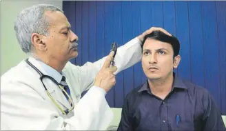  ??  ?? Endocrinol­ogist Dr Anoop Misra, chairman of Fortis C-Doc, examines a patient in New Delhi. SAUMYA KHANDELWAL