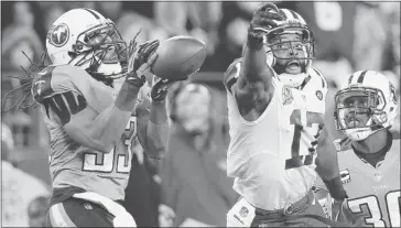  ?? Joe Howell/the Associated Press ?? Titans safety Michael Griffin intercepts a pass meant for New York Jets wide receiver Braylon Edwards on Monday.