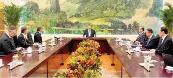  ?? — AFP photo ?? Xi (centre) holding a meeting with Blinken (third left) at the Great Hall of the People in Beijing.