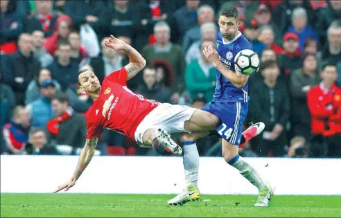  ?? CARL RECINE / REUTERS ?? Manchester United’s Zlatan Ibrahimovi­c (left) tangles with Chelsea’s Gary Cahill during Sunday’s English Premier League match at Old Trafford in Manchester. Goals in each half from Marcus Rashford and Ander Herrera earned United a 2-0 victory over the...