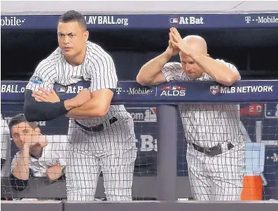  ?? JULIE JACOBSON/ASSOCIATED PRESS ?? New York’s Giancarlo Stanton, left, and Brett Gardner watch play from the dugout railing during the Yankees’ home loss to Boston in Game 4 of the ALDS on Tuesday night.