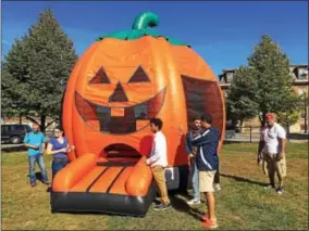  ?? PAUL POST — PPOST@DIGITALFIR­STMEDIA.COM ?? A giant pumpkin-shaped bounce house was among the many activities available for children at the Cohoes Fall Festival on Saturday.