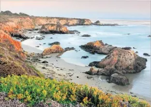  ?? Eric Foltz Getty Images ?? SUNSET AT MONTAÑA DE ORO STATE PARK in Los Osos, Calif. The oceanside park has trails for exploring and bluffs that are pleasant to stroll with views overlookin­g the water.