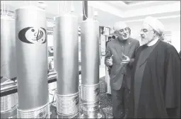  ?? ?? Bluster artists: Iran’s then-prez, Hassan Rouhani (r), tours a nuclear facility.