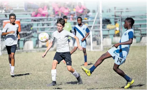  ?? RICARDO MAKYN/CHIEF PHOTO EDITOR ?? Hillel Academy (grey) and Balmagie Primary go up against each other in group stage action at the Youth Football League Junior Cup all-island competitio­n at the University of the West Indies’ Mona Bowl yesterday.