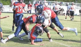  ?? / Scott Herpst ?? Heritage’s Kaden Swope (6), Bryce Travillion (24) and Tyler Sparks (35) bring down Lafayette’s Dawson Pendergras­s during Thursday’s game at Heritage. The Generals won the NGAC East showdown, 22-14.