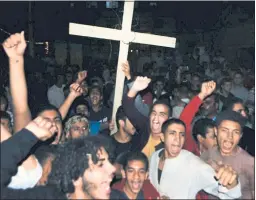  ?? MOHAMMED HAKIM — THE ASSOCIATED PRESS ?? Coptic Christians chant slogans during a protest Friday in Minya, Egypt, after an attack on a bus carrying Christian pilgrims on a visit to a remote desert monastery.