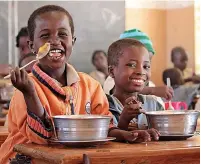  ?? ?? ●●Young children in Benin enjoy a serving of Mary’s Meals .