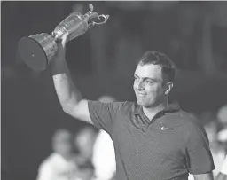  ?? ANDY BUCHANAN/AFP/GETTY IMAGES ?? Italy’s Francesco Molinari hoists the Claret Jug, the trophy for the British Open on Sunday in Carnoustie, Scotland.