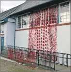  ??  ?? The knitted poppy display at Brodick Hall has varied colours to represent the different victims of the First World War.