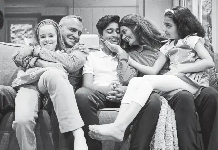  ?? CHRISTOPHE­R KATSAROV THE CANADIAN PRESS ?? Parents Kamran and Reshma Niazi pose with their children, from left, Lilly (8), Jaffar (14) and Aaliya (7) in their home in Oakville. The couple became foster parents 13 years ago and have cared for between 15 and 20 children, Reshma Niazi said.