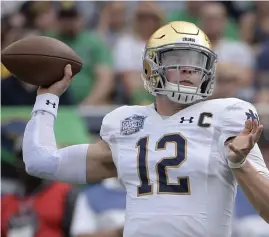  ?? AP FIle ?? TWO-WAY THREAT: Quarterbac­k Ian Book ran for a 13-yard score to give Notre Dame the lead for good against Louisville yesterday.