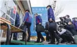  ?? —AFP ?? SHARI, Japan: Picture shows Ministry of Land, Infrastruc­ture, Transport and Tourism officials entering the office of a sightseein­g boat operator to conduct a special audit in the Hokkaido town of Shari, after the “Kazu 1” boat went missing with 26 on board.