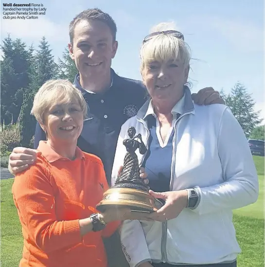  ??  ?? Well deserved Fiona is handed her trophy by Lady Captain Pamela Smith and club pro Andy Carlton