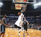  ?? Associated Press ?? New Orleans Pelicans forward DeMarcus Cousins dunks during Friday night’s game against the Sacramento Kings in New Orleans. Cousins finished with 37 points and 13 rebounds in his first game against his former team.